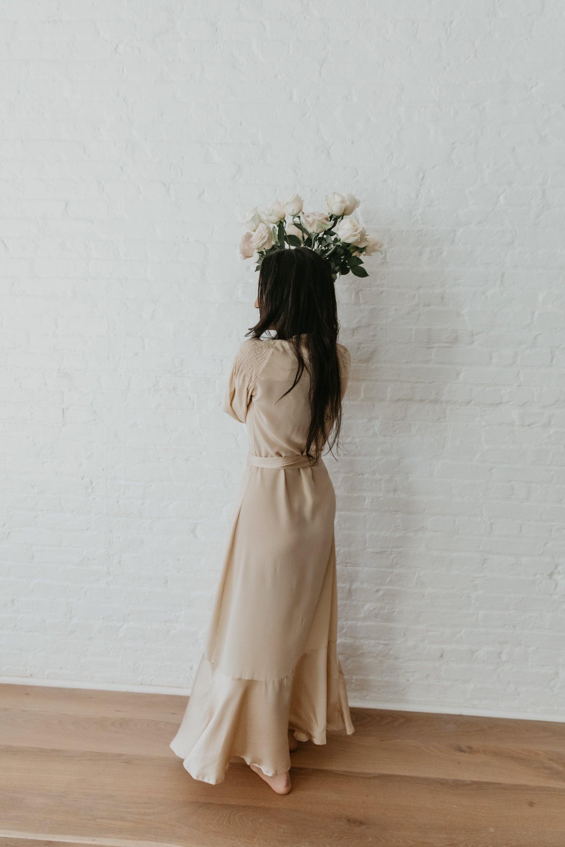 women wearing Champagne silk dress with deep V neckline and wrap waist
