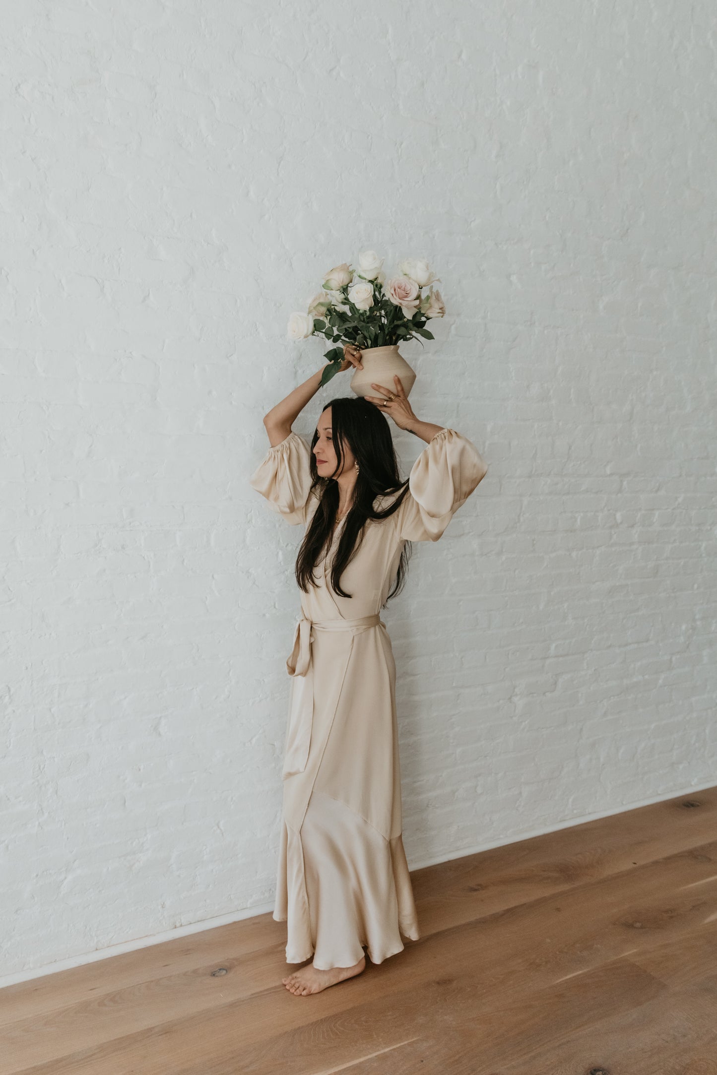 women wearing Luxury silk wrap dress styled with desert inspired backdrop
