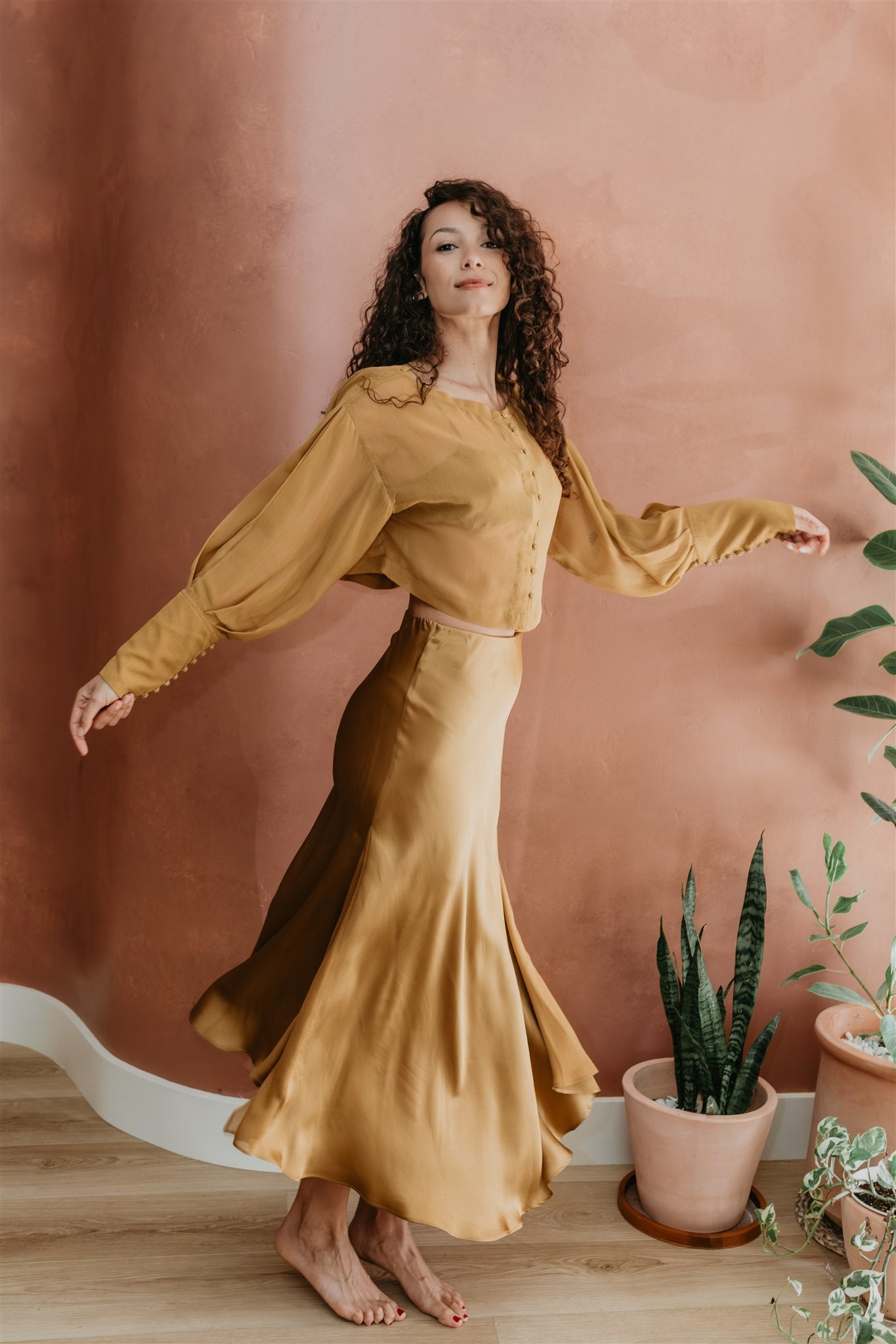 women wearing silk skirt with chiffon blouse in brass