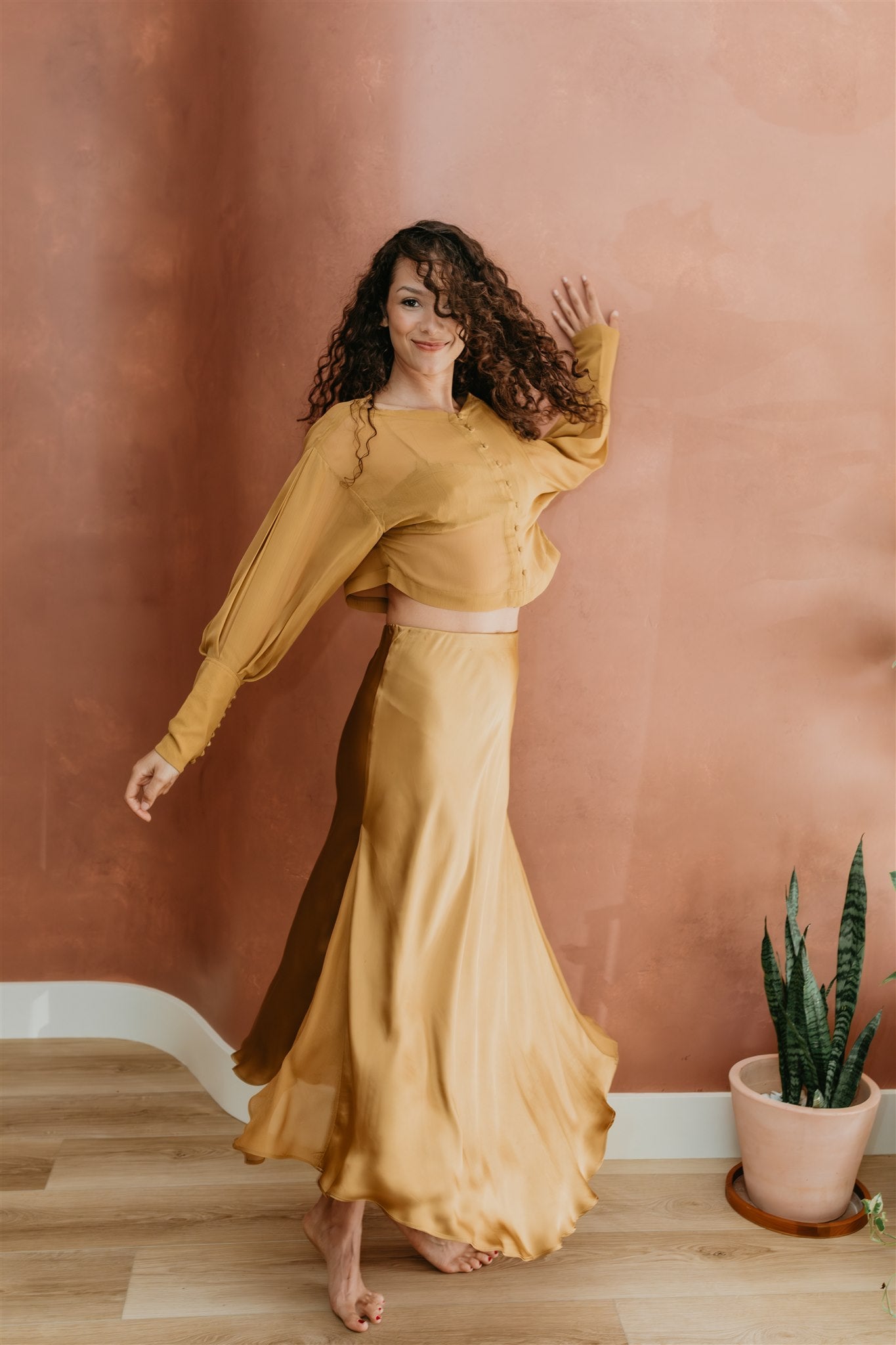 women wearin silk skirt in brass by PAYET Maison