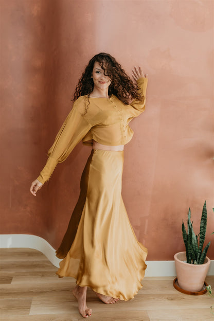 women wearin silk skirt in brass by PAYET Maison
