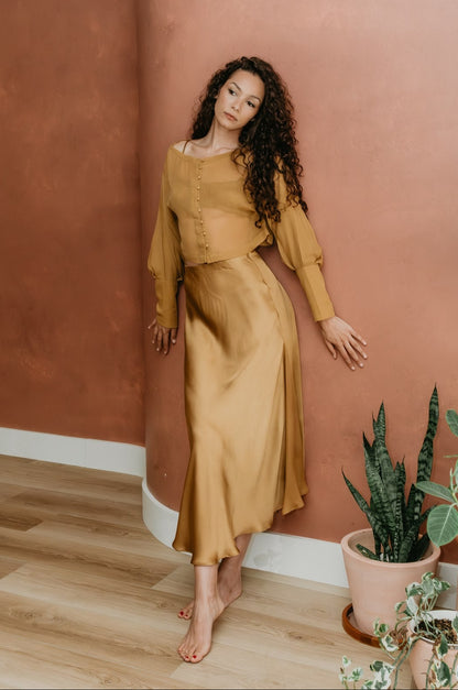 women wearing eclipse brass top and aura skirt bass
