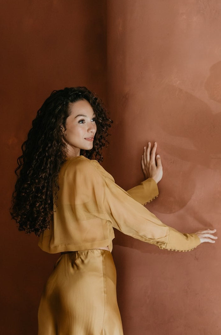 women in beautiful brass blouse in brass color