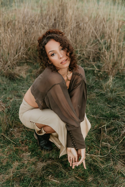 women wearing silk top sitting in the grass