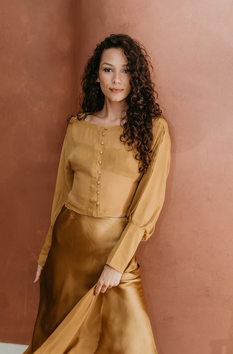 women in gold chiffon silk blouse