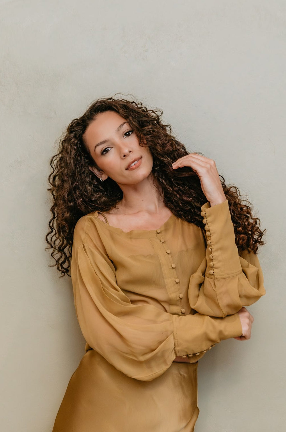 women wearing a chiffon brass top