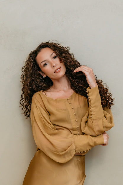 women wearing a chiffon brass top