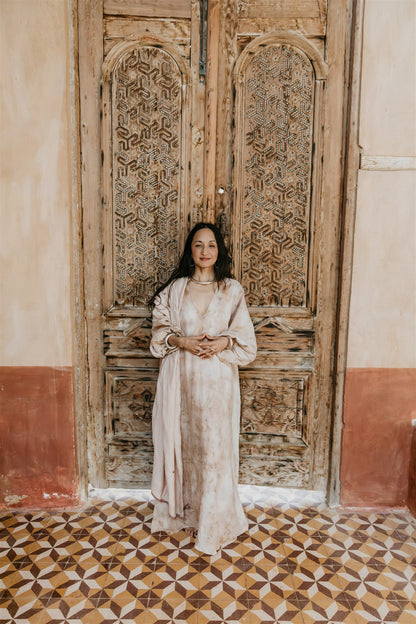 Woman wearing Nomad Linen Kaftan Dress By Payet Maison with deep V neckline and ballon sleeves.