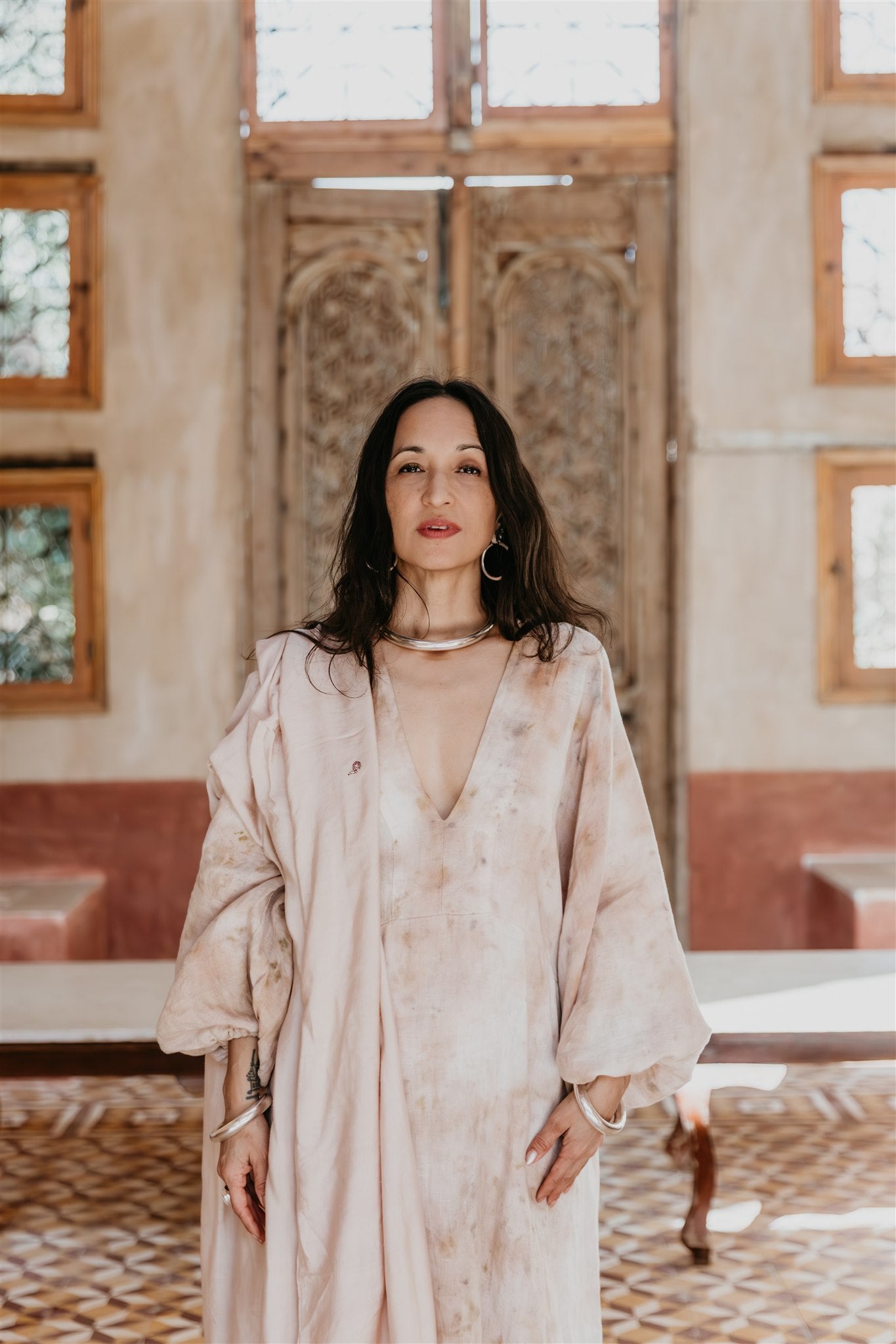 Woman wearing the Nomad Linen Kaftan by Payet Maison, a flowing botanical dyed linen dress with balloon sleeves.