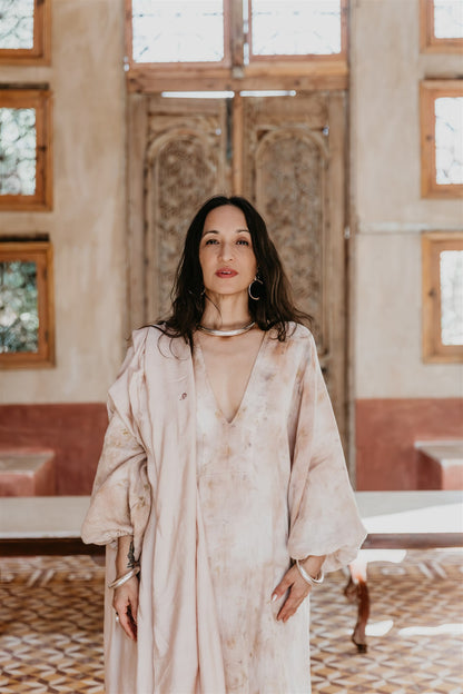 Woman wearing the Nomad Linen Kaftan by Payet Maison, a flowing botanical dyed linen dress with balloon sleeves.