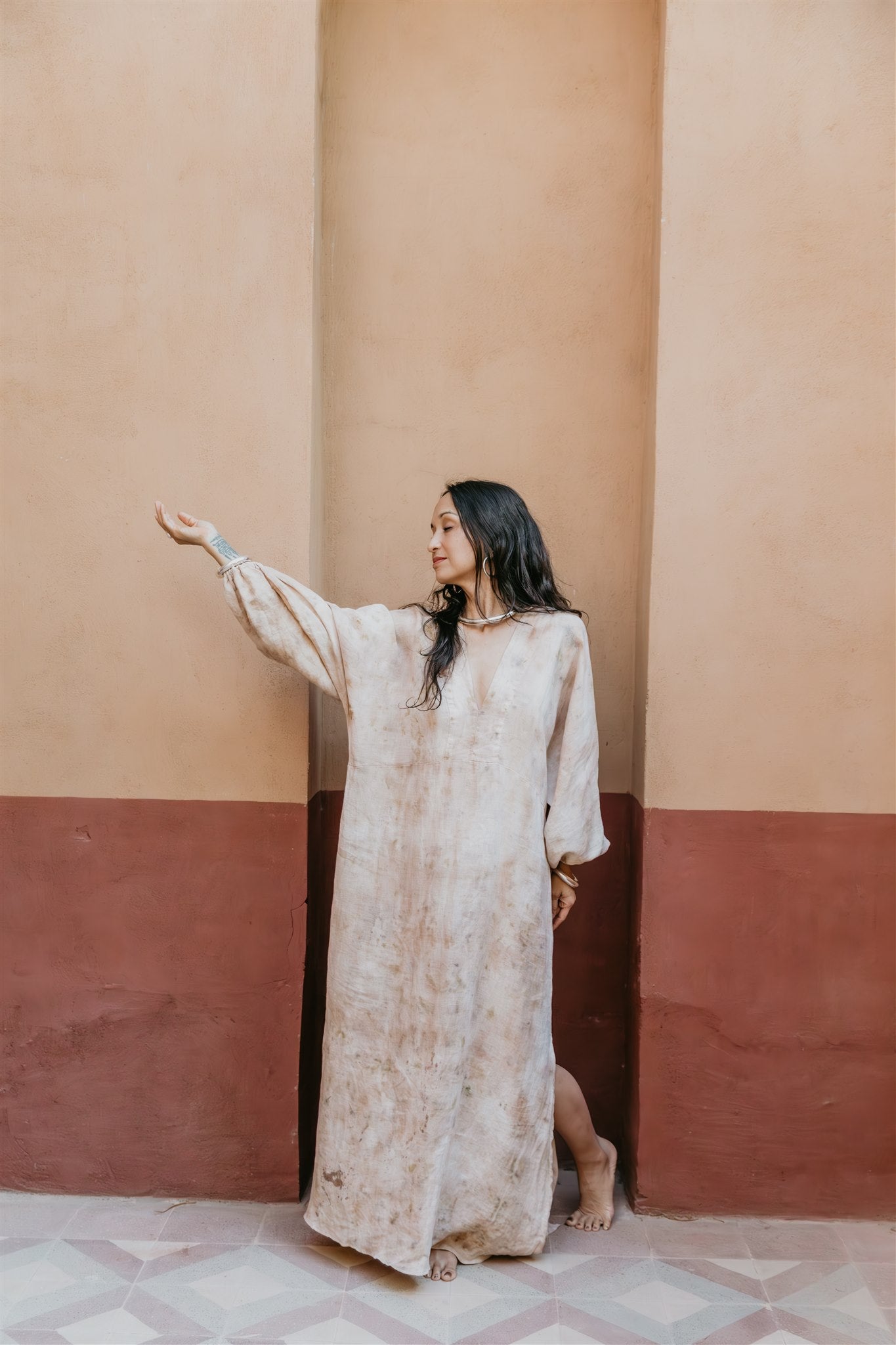Woman wearing Nomad Linen Kaftan in natural linen by Payet Maison, a relaxed bohemian resort dress.