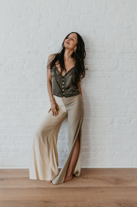 Model wearing sage and champagne two-tone silk pants
Flowing silk pants with side slit in sage and champagne