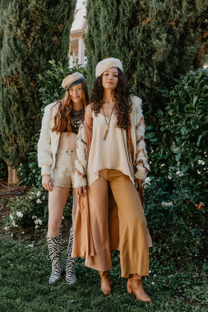 women wearing Relaxed fit silk trousers in dual color palette
Luxury silk pants styled in natural garden setting