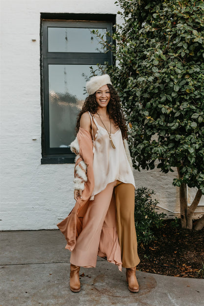 women wearing Elegant silk pants in earthy peach and brass tones