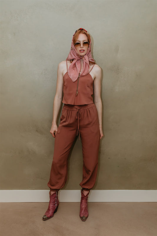 Model wearing Zola Silk Drawstring Pants in Plum by Payet Maison, flowing peace silk trousers with relaxed drawstring waist.
