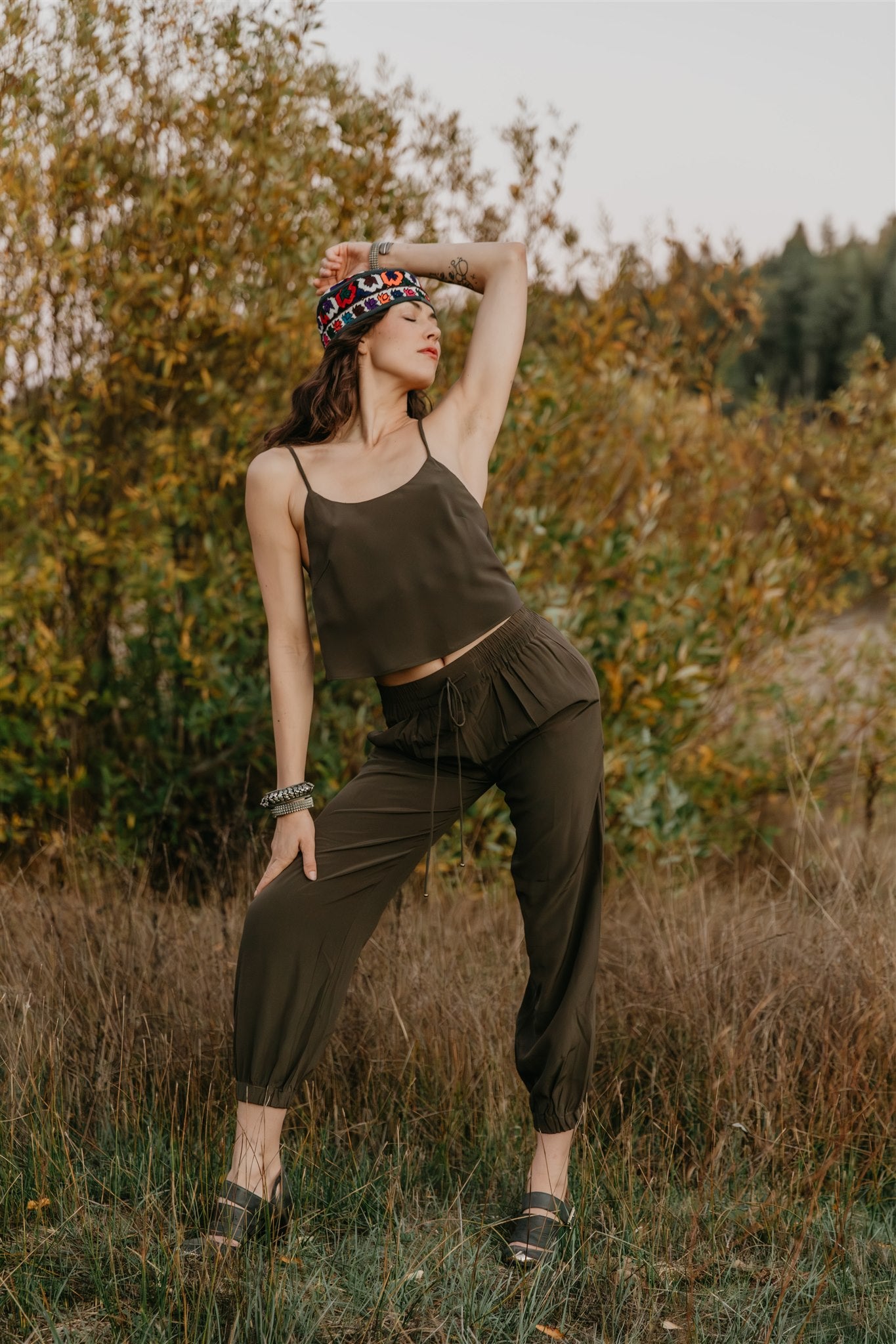 Model wearing Zola Silk Drawstring Pants in Licorice by Payet Maison, flowing peace silk trousers with relaxed drawstring waist.
