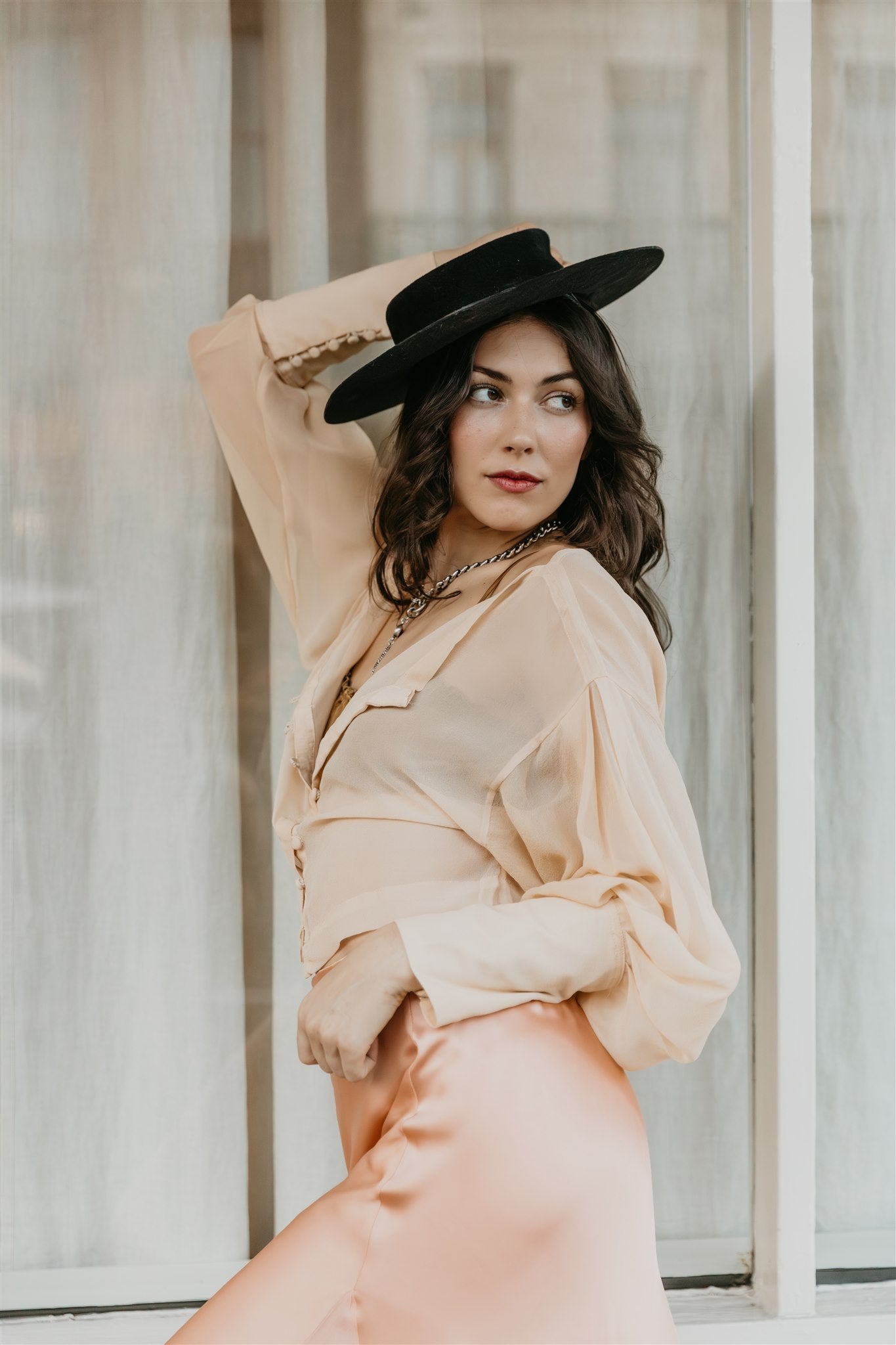woman wearing champagne chiffon silk blouse with buttons front
