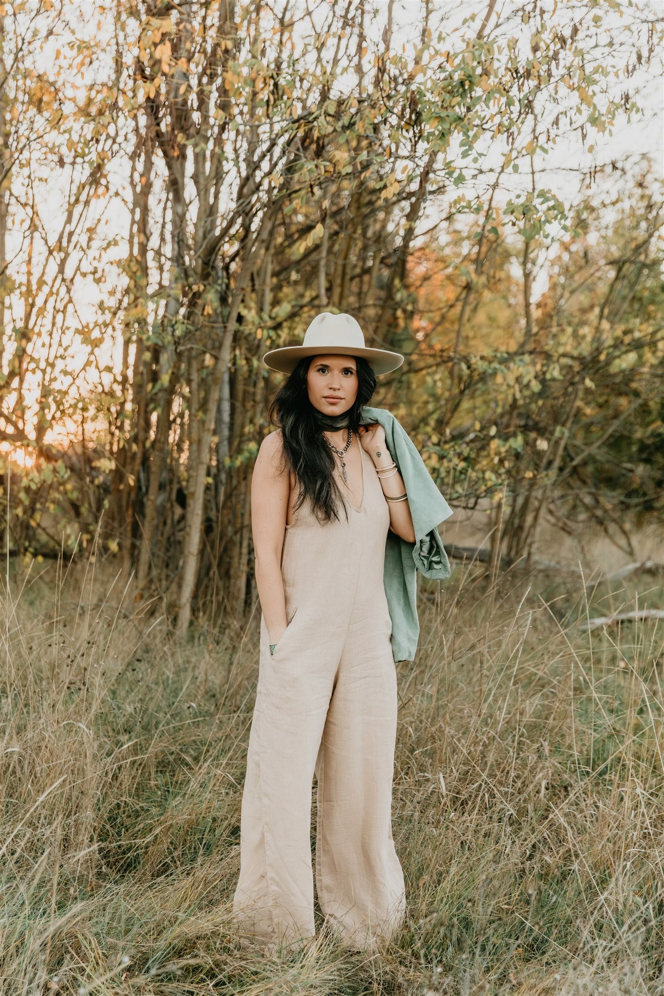 women wearing  linen wide leg jumpsuit with v neck front and back