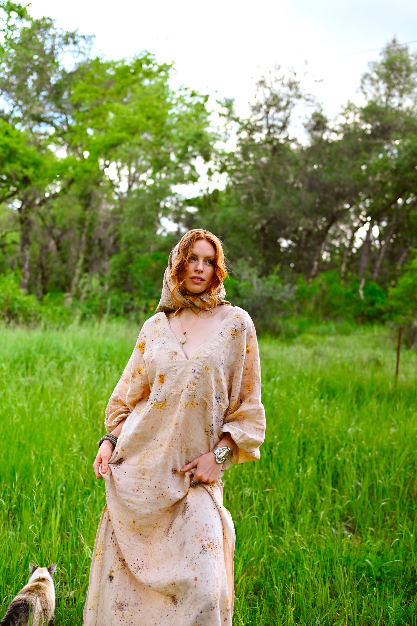 Deep V-neckline detail on The Flora Dress with botanical eco-print in golden amber and violet on natural cream linen by Payet Maison