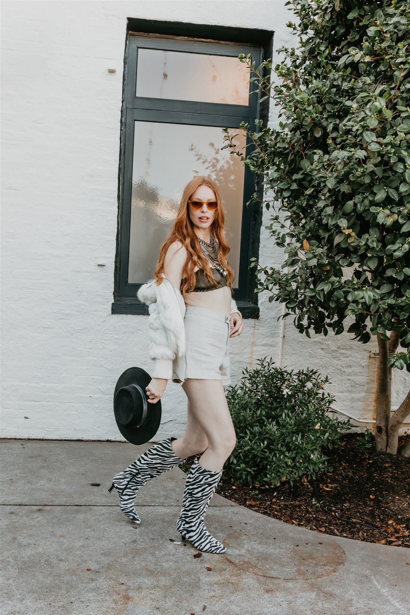 women wearing neutral linen shorts styled with silk top