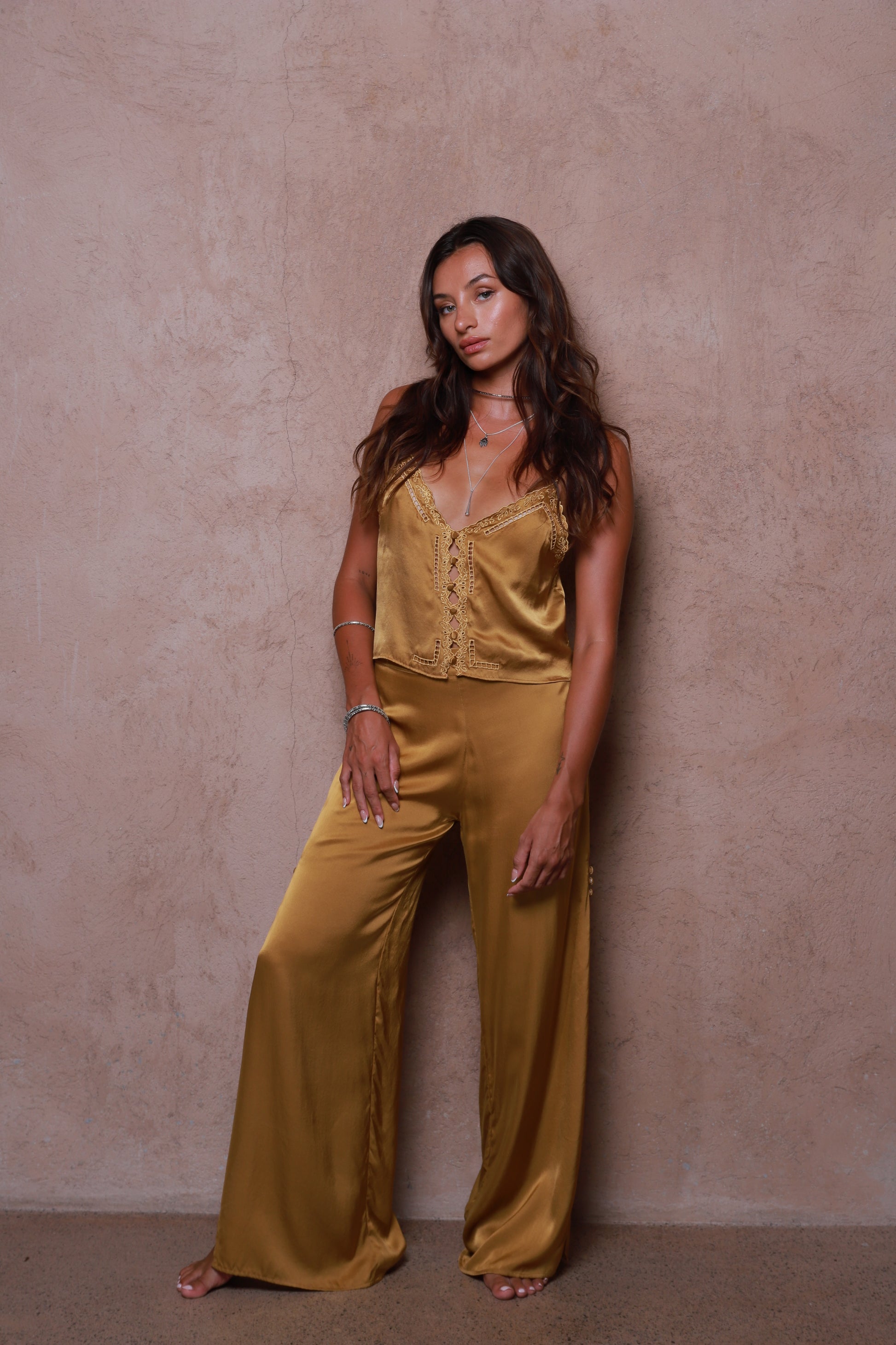 women wearing Veda silk pants gold tone relaxed fit outfit
Ethical silk pants Bali handcrafted brass color