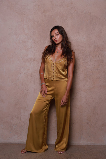 women wearing Veda silk pants gold tone relaxed fit outfit
Ethical silk pants Bali handcrafted brass color