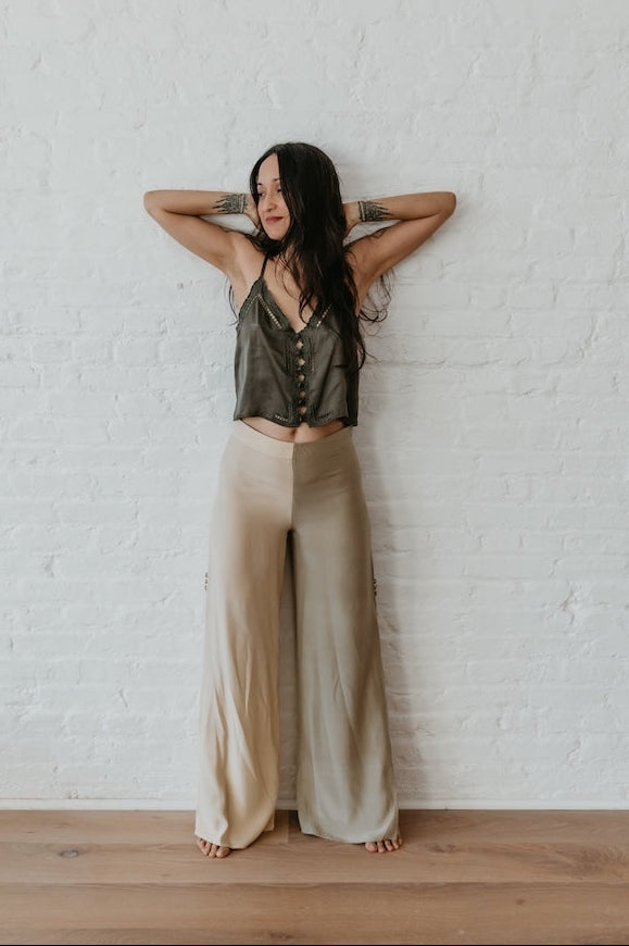 model wearing Two-tone silk trousers styled in neutral indoor setting	Relaxed fit silk pants with slit detail