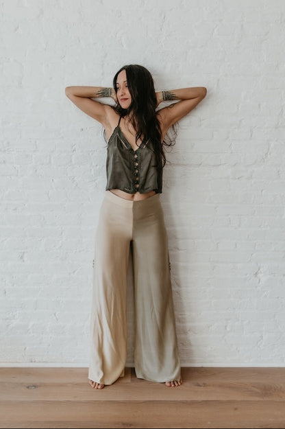 model wearing Two-tone silk trousers styled in neutral indoor setting	Relaxed fit silk pants with slit detail