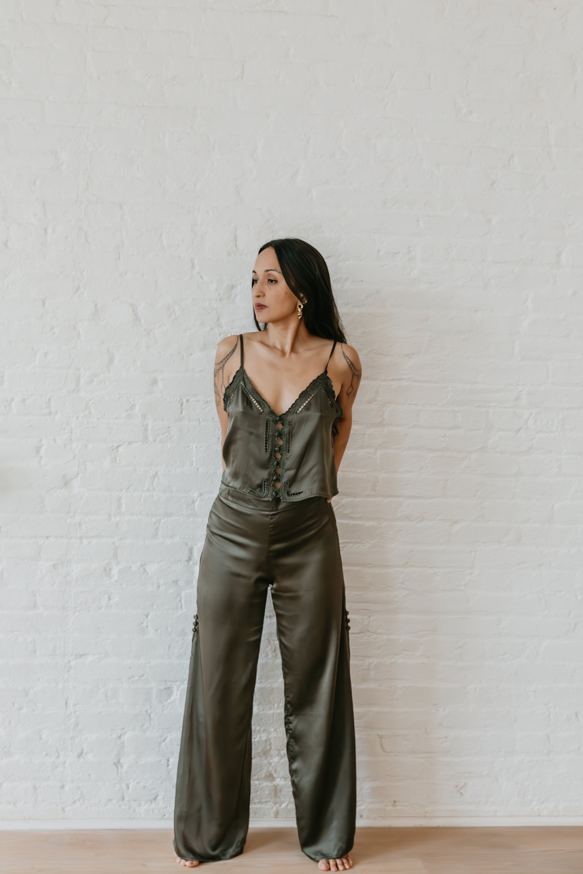 women wearing Silk pants with slit detail styled on steps,Relaxed fit black silk pants with fluid drape